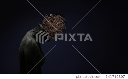 Silhouetted woman bows her head with tangled wire, mental stress, confusion, anxiety, Silhouetted woman bows her head with tangled wire, mental stress, confusion, anxiety, 141719807