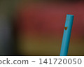 A plastic straw with tea stains at the tip. 141720050