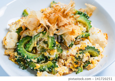 Goya Champuru (Okinawan stir-fry with tofu and egg) on a white background - Okinawan home cooking Goya Champuru (Okinawan stir-fry with tofu and egg) on a white background - Okinawan home cooking 141720251