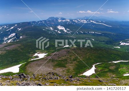 A spectacular view of Mount Tomuraushi and its remaining snow, seen from the summit of Mt. Hakunodake in the Daisetsuzan Mountains of Hokkaido. A spectacular view of Mount Tomuraushi and its remaining snow, seen from the summit of Mt. Hakunodake in the Daisetsuzan Mountains of Hokkaido. 141720517