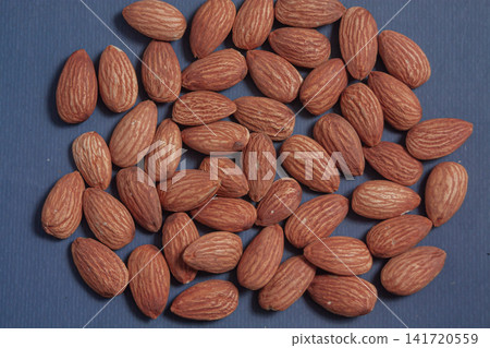 Almonds rest on a simple piece of paper, Almonds rest on a simple piece of paper, 141720559