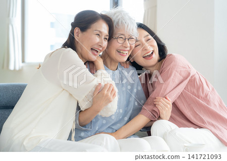 A middle-aged female friend relaxing in the living room 141721093