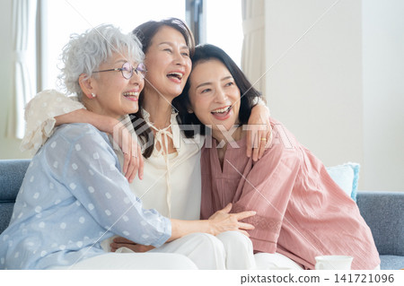 A middle-aged female friend relaxing in the living room A middle-aged female friend relaxing in the living room 141721096