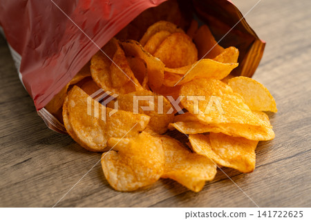 Potato chips , delicious BBQ seasoning spicy for crips, thin slice deep fried snack fast food. Potato chips , delicious BBQ seasoning spicy for crips, thin slice deep fried snack fast food. 141722625