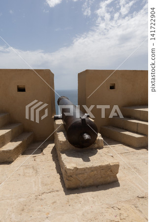Old cannon guarding the historic castillo de santa barbara with the sea in the background Old cannon guarding the historic castillo de santa barbara with the sea in the background 141722904