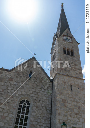 Evangelical Church of Christ in Hallstatt with a High Bell Tower on a Sunny Day in the Mountains 141723539