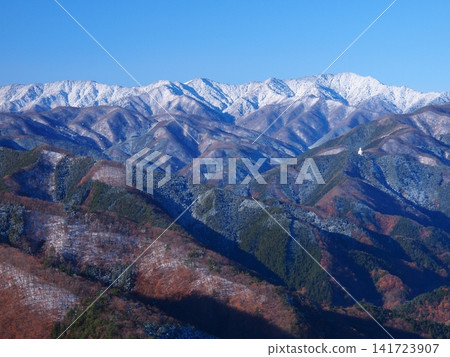 The snow-capped Daibosatsu mountain range as seen from the climbing trail of Mt. Gozen in late autumn. 141723907