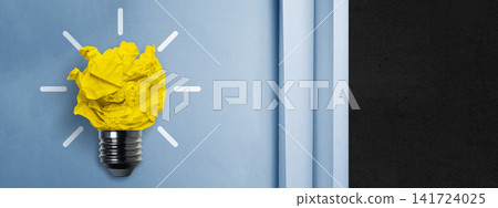 Creative light bulb concept made of crumpled yellow paper on a blue background peeling back to reveal a dark surface. Great banner for ideas and innovation. Concept of Idea Creative light bulb concept made of crumpled yellow paper on a blue background peeling back to reveal a dark surface. Great banner for ideas and innovation. Concept of Idea 141724025