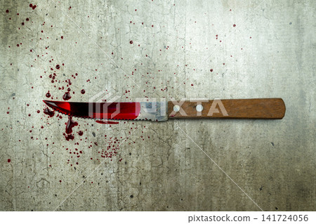 A bloody knife with a wooden handle lies on a concrete floor surrounded by fresh blood splatters, representing a crime scene. Concept of Halloween A bloody knife with a wooden handle lies on a concrete floor surrounded by fresh blood splatters, representing a crime scene. Concept of Halloween 141724056