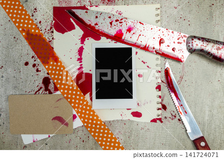 Horror crime scene flat lay with bloody knives, splattered paper, blank instant photo frame, and lipstick-stained card on a concrete background. Concept of Halloween Horror crime scene flat lay with bloody knives, splattered paper, blank instant photo frame, and lipstick-stained card on a concrete background. Concept of Halloween 141724071