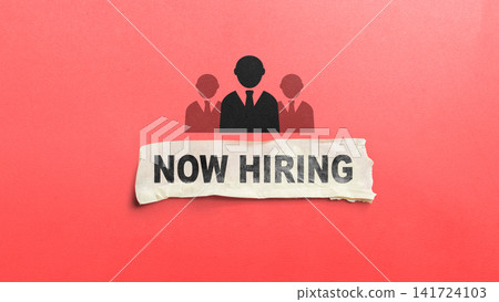Torn paper with "Now Hiring" text under business team icons on a red background, representing recruitment. HR Recruitment concept Torn paper with "Now Hiring" text under business team icons on a red background, representing recruitment. HR Recruitment concept 141724103