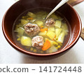 Bowl of Soup with Meatballs, Green Peas and other Vegetables. 141724448