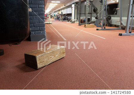 Gym interior with wooden block on rubber floor soft ambient lighting with pleasant warm tones and motivating atmosphere. Gym interior with wooden block on rubber floor soft ambient lighting with pleasant warm tones and motivating atmosphere. 141724580