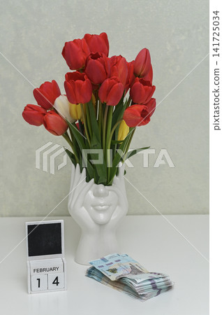tulip bouquet in white ceramic vase with hands base, tulip bouquet in white ceramic vase with hands base, 141725034