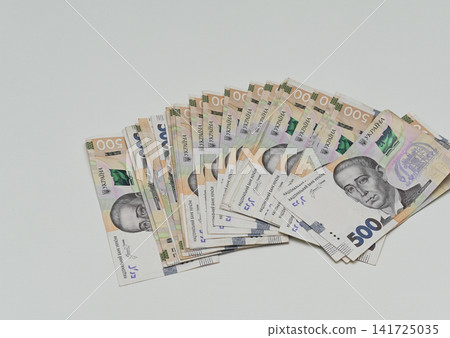 Abundant heap of national currency bills lies scattered on background. 141725035