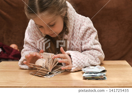 Cute girl counting money. Cute girl counting money. 141725435