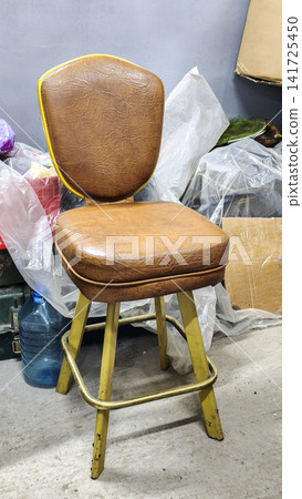 Vintage wooden chair with a worn leather seat and yellow-painted legs, Vintage wooden chair with a worn leather seat and yellow-painted legs, 141725450