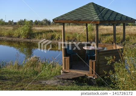 Wooden gazebo by tranquil pond, Wooden gazebo by tranquil pond, 141726172