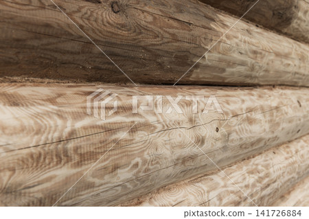 Close-up view of a sanded log cabin wall featuring natural wood grain Close-up view of a sanded log cabin wall featuring natural wood grain 141726884