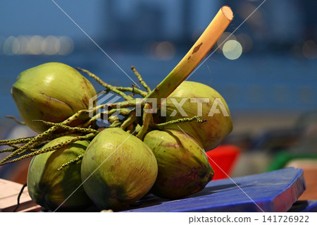 Fresh green coconuts lined up in a tropical market 141726922