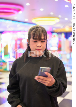 Close-Up Portrait of Woman Using Mobile Phone Close-Up Portrait of Woman Using Mobile Phone 141726942