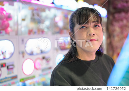 Close-Up Frontal Portrait of Asian Woman in Arcade 141726952