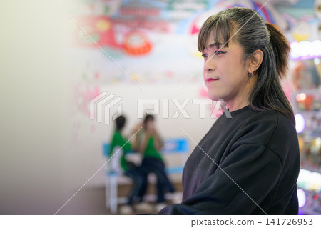 Side Profile Portrait of Woman in Arcade Game Hall 141726953