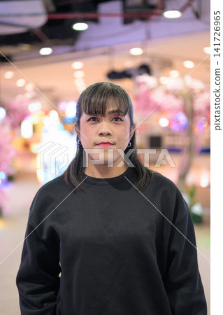 Vertical Medium Portrait of Asian Woman in Arcade Vertical Medium Portrait of Asian Woman in Arcade 141726965