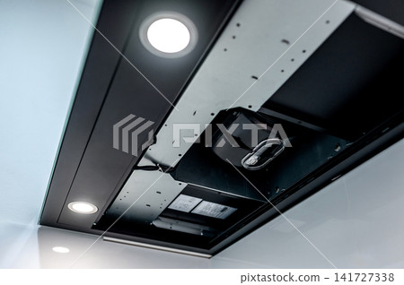 Modern black cooker hood with range hood filter removed showing extractor motor inside Modern black cooker hood with range hood filter removed showing extractor motor inside 141727338