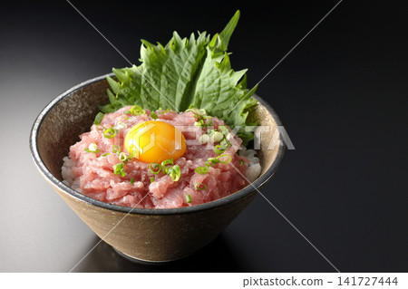 Negitoro Donburi and Tuna Tataki Donburi photographed against a black background. Negitoro Donburi and Tuna Tataki Donburi photographed against a black background. 141727444