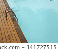 Poolside Ladder and Steps in Turquoise Water 141727515
