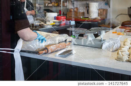 Raw bread dough portions on a table in a commercial bakery. Food production facility 141727645