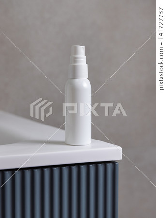 White spray cosmetic bottle mockup on blue bathroom vanity. Skincare cosmetic packaging White spray cosmetic bottle mockup on blue bathroom vanity. Skincare cosmetic packaging 141727737