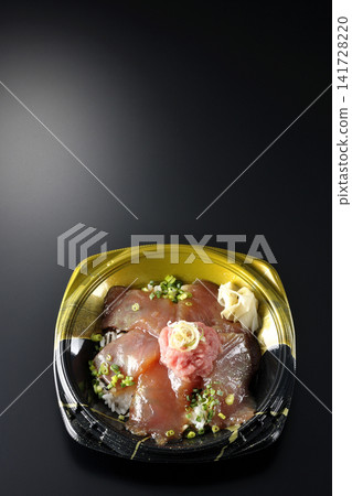 A photo of a negitoro and marinated tuna rice bowl bento box against a black background. A photo of a negitoro and marinated tuna rice bowl bento box against a black background. 141728220