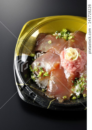 裝有金槍魚碎和醃金槍魚的便當盒，在黑色背景下拍攝。 141728226