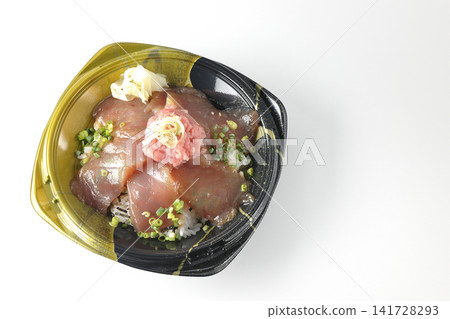 A photo of a bento box containing negitoro (minced tuna with green onions) and marinated tuna rice bowl against a white background. A photo of a bento box containing negitoro (minced tuna with green onions) and marinated tuna rice bowl against a white background. 141728293