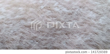 Full frame close up of a white or light gray fluffy surface resembling a soft rug or blanket. Full frame close up of a white or light gray fluffy surface resembling a soft rug or blanket. 141728389