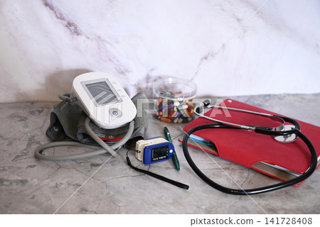 Medical supplies and equipment on a blue surface with a focus on tools for health monitoring and examination Medical supplies and equipment on a blue surface with a focus on tools for health monitoring and examination 141728408