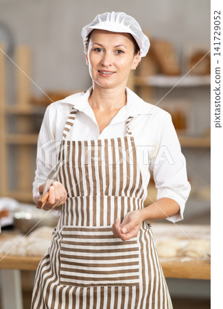 Adult female baker posing in workshop Adult female baker posing in workshop 141729052