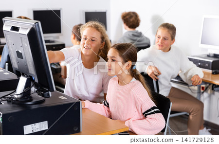 Portrait of female and male students working on computers in class room Portrait of female and male students working on computers in class room 141729128