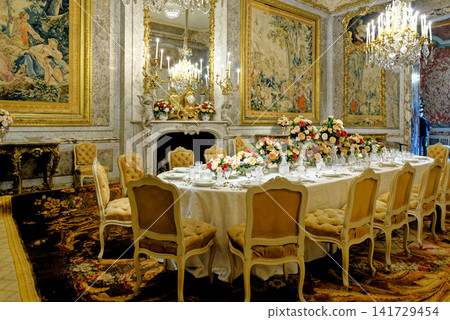The opulent formal dining room interior with gilded decor and tapestries at Waddesdon Manor 141729454