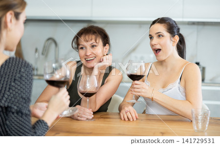 Three women have nice chat-in with wine and conversation Three women have nice chat-in with wine and conversation 141729531
