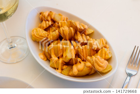 Spanish Patatas bravas, baked potatoes with spicy aioli sauce Spanish Patatas bravas, baked potatoes with spicy aioli sauce 141729668