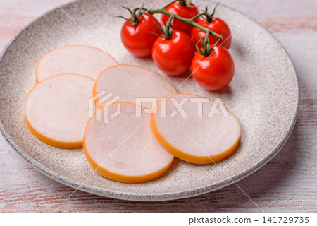 Slices of boiled chicken or pork sausage as an ingredient for home cooking. Sliced boiled sausage 141729735