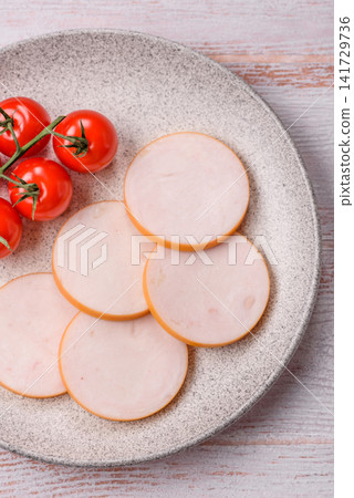 Slices of boiled chicken or pork sausage as an ingredient for home cooking. Sliced boiled sausage Slices of boiled chicken or pork sausage as an ingredient for home cooking. Sliced boiled sausage 141729736