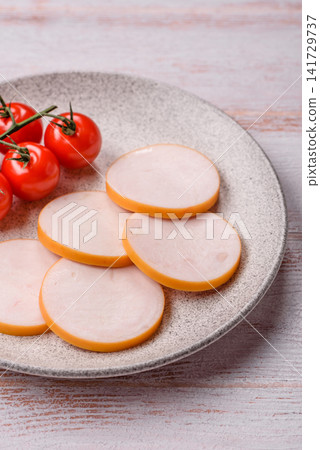 Slices of boiled chicken or pork sausage as an ingredient for home cooking. Sliced boiled sausage Slices of boiled chicken or pork sausage as an ingredient for home cooking. Sliced boiled sausage 141729737