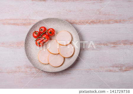 Slices of boiled chicken or pork sausage as an ingredient for home cooking. Sliced boiled sausage Slices of boiled chicken or pork sausage as an ingredient for home cooking. Sliced boiled sausage 141729738