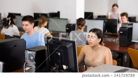 Teenage girl using computer during lesson Teenage girl using computer during lesson 141729789