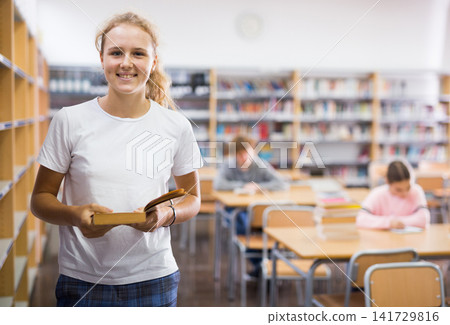 Teenager girl in library 141729816