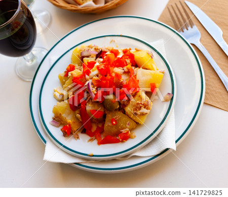 Salad with boiled potatoes, eggs, canned tuna, olives, bell peppers, onions 141729825